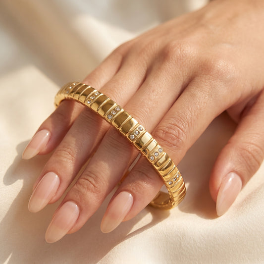 Gold-Tone Segmented Bangle Bracelet with Inset Crystal Accents